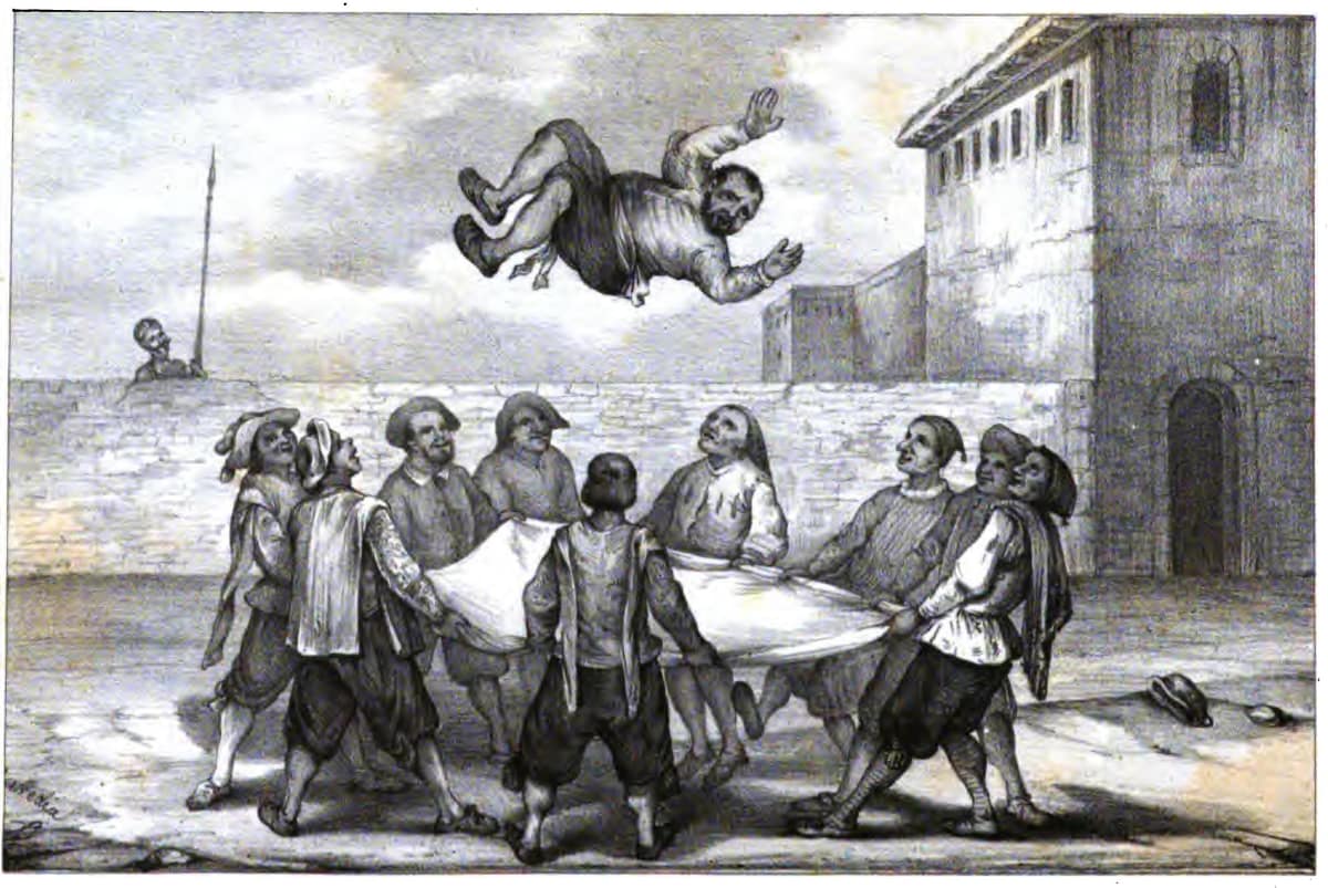 Varios hombres lanzan a Sancho Panza al aire con una manta en el patio de la venta.