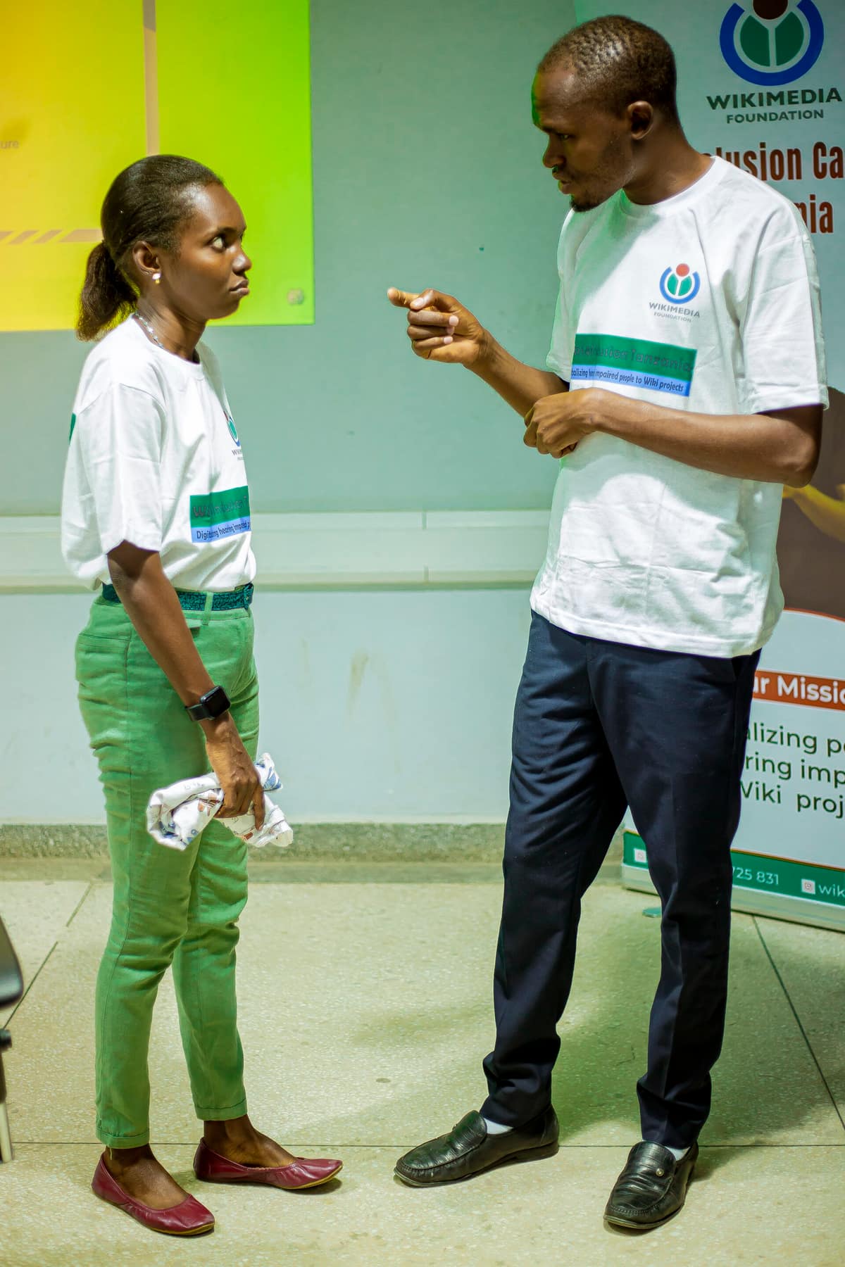 Imagen de A sign language interpreter with a deaf participant.jpg. A sign language interpreter communicating with a deaf participant by Tanzanian Sign language (TSL) during the Wiki4Inclusion training event at dLab Tanzania, Kijitonyama Dar es esaam Tanzania.